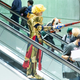 Costumed (and masked) attendees on an escalator at Anime NYC in November 2021.
